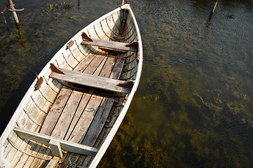 Image showing Lonely boat floating on water at the bay