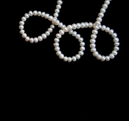 Image showing White pearls on the black silk 