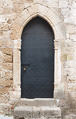 Image showing Old black medieval door with sliding door bolt