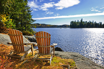 Image showing Adirondack chairs at lake shore