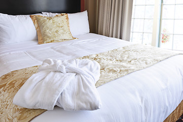 Image showing Hotel bed with bathrobe