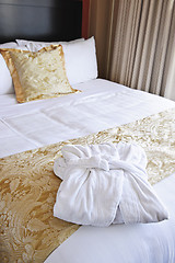 Image showing Hotel bed with bathrobe