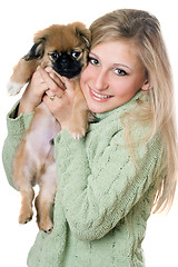 Image showing Young blonde with a puppy