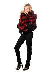 Image showing Pretty blonde posing in fur jacket. Isolated