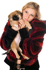 Image showing Beautiful blonde holding a pekinese