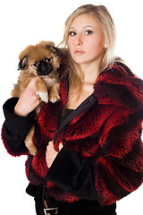 Image showing Attractive woman holding a pekinese