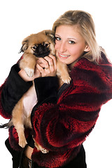 Image showing Young woman holding a pekinese