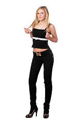 Image showing Young pretty woman in black pants. Isolated