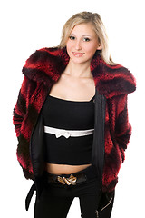 Image showing Smiling young blond woman in a fur jacket