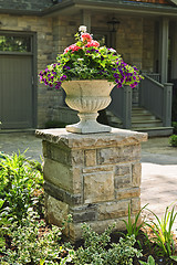 Image showing Stone planter in front of house