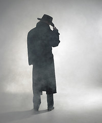 Image showing Woman wearing trench coat and standing in fog