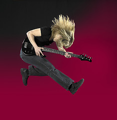 Image showing jumping bass guitar woman