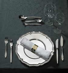 Image showing feastful place setting on green tablecloth