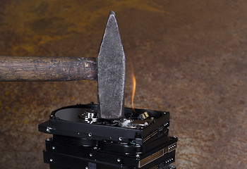 Image showing hammer and burning hard disks