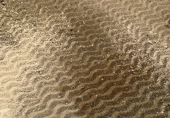 Image showing wavy lines on brown sand surface