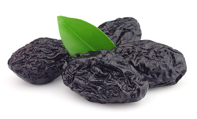 Image showing Dried prunes with leaves