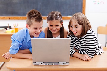 Image showing Happy kids looking at laptop