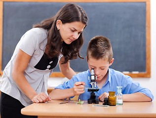 Image showing Boy looking into microscope