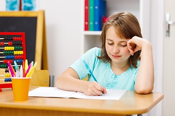 Image showing Schoolgirl writing homework