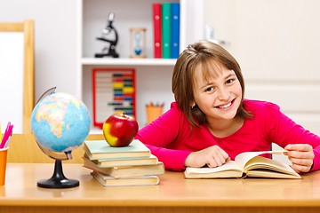 Image showing Schoolgirl reading in classroom