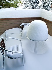 Image showing Table and chairs covered in snow
