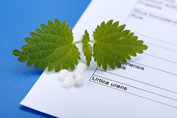 Image showing Urica Urens and pills on homeopathic sheet