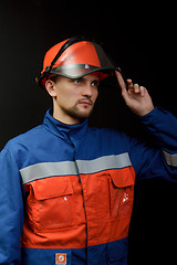 Image showing The worker in overalls and a helmet
