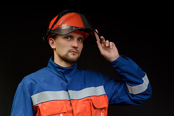 Image showing The worker in overalls and a helmet