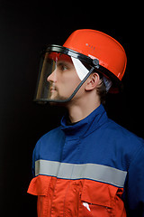 Image showing The worker in overalls and a helmet