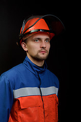 Image showing The worker in overalls and a helmet