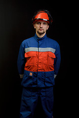 Image showing The worker in overalls and a helmet