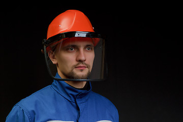 Image showing The worker in overalls and a helmet