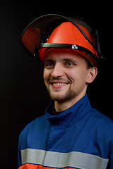 Image showing The worker in overalls and a helmet