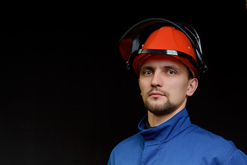 Image showing The worker in overalls and a helmet