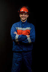 Image showing The worker in overalls and a helmet