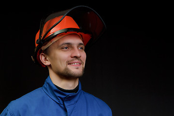 Image showing The worker in overalls and a helmet