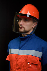 Image showing The worker in overalls and a helmet