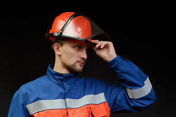 Image showing The worker in overalls and a helmet