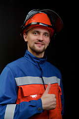 Image showing The worker in overalls and a helmet