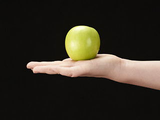 Image showing Childs hand with apple in palm