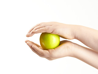 Image showing Apple sandwiched between childs hands