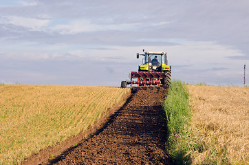 Image showing Tractor plow agricultural field harvested land 