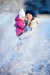 Image showing Mother and daughter outdoors at winter