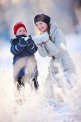 Image showing Mother and son outdoors at winter