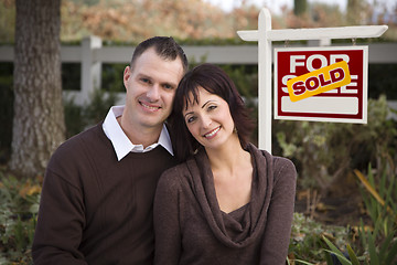 Image showing Happy Couple in Front of Sold Real Estate Sign