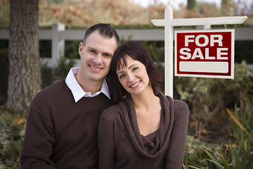 Image showing Happy Couple in Front of Real Estate Sign