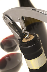 Image showing Corkscrew opening wine bottle 