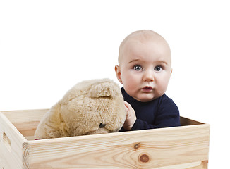 Image showing young child with toy in wooden box