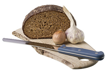 Image showing brown bread on shelf with onion and garlic