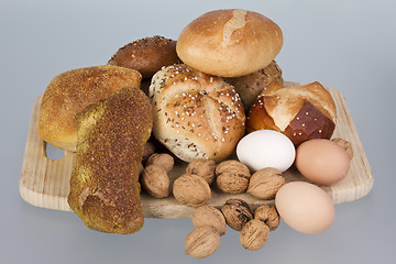 Image showing gem, nuts and eggs on a wooden board